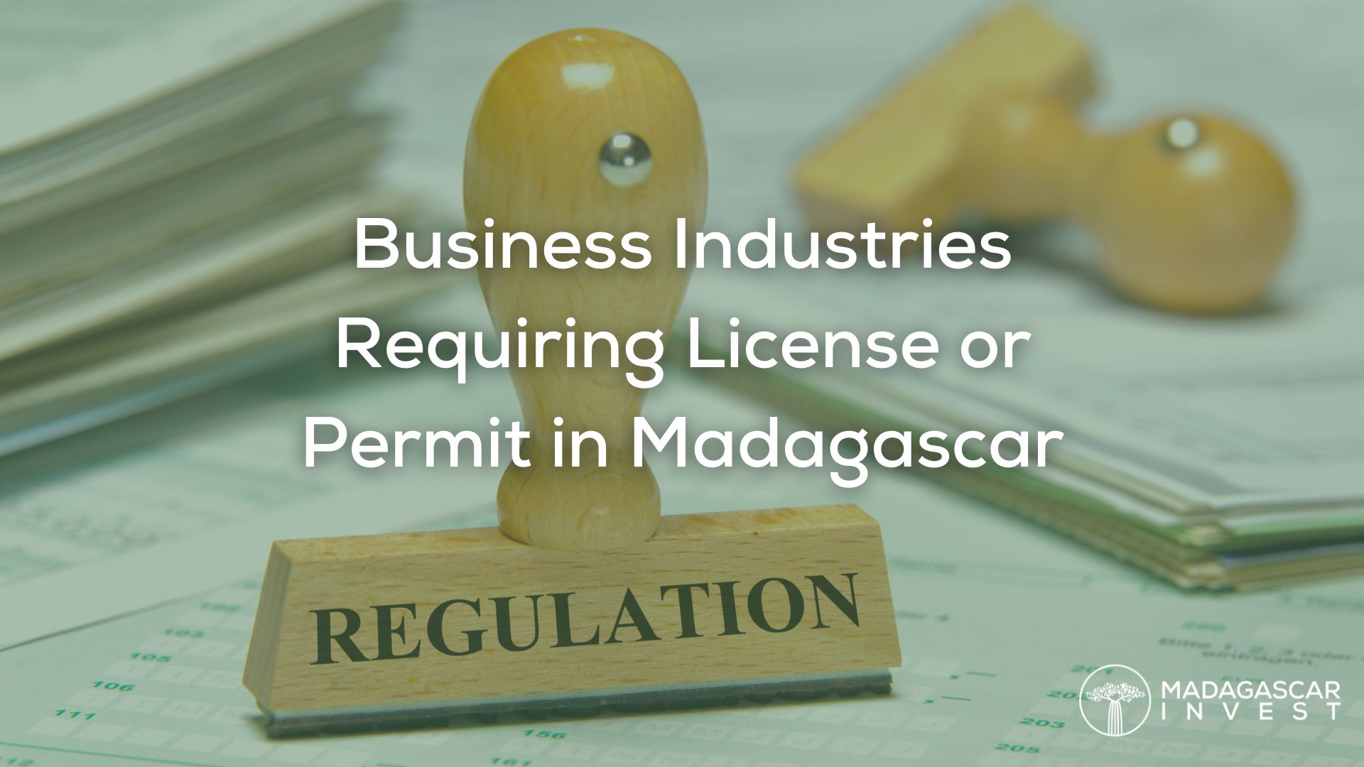 a regulation stamp with a green overlay and the text business industries requiring license or permit in madagascar followed by the madagascar invest logo