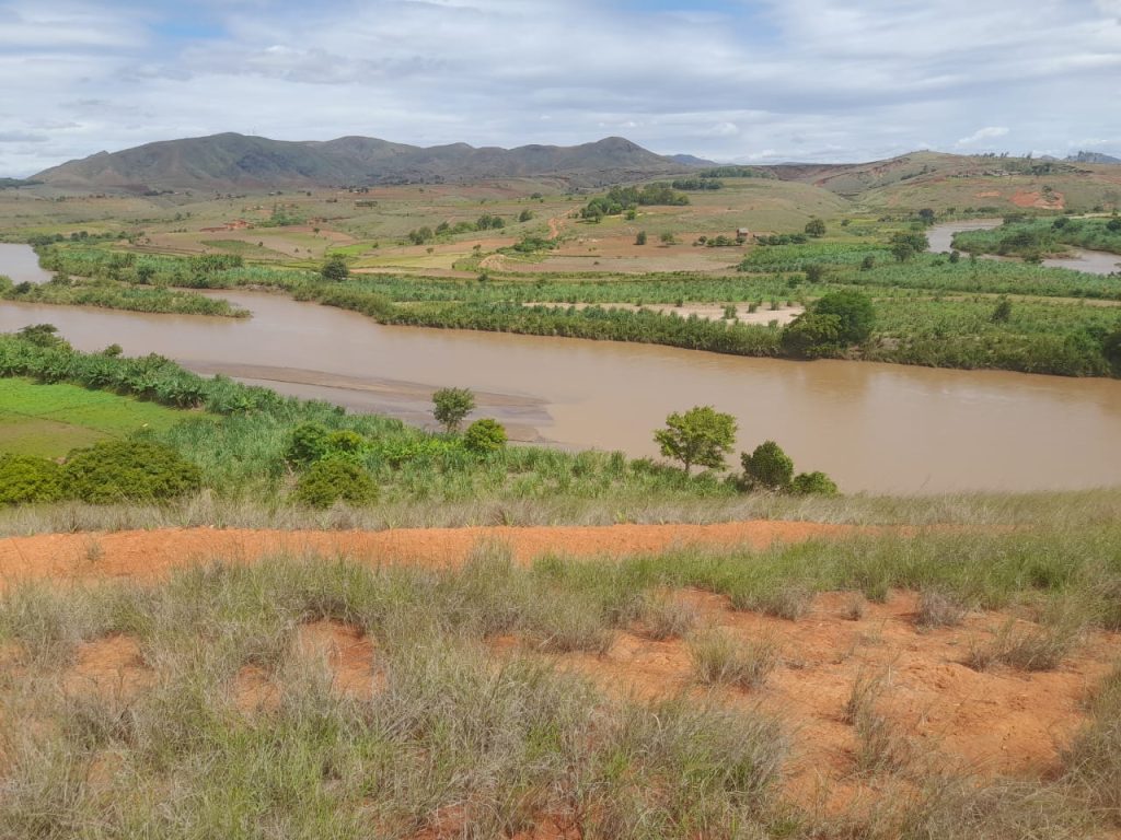 image showing a piece of madagascar farmland with a river flowing through it