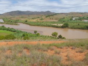 image showing a piece of madagascar farmland with a river flowing through it